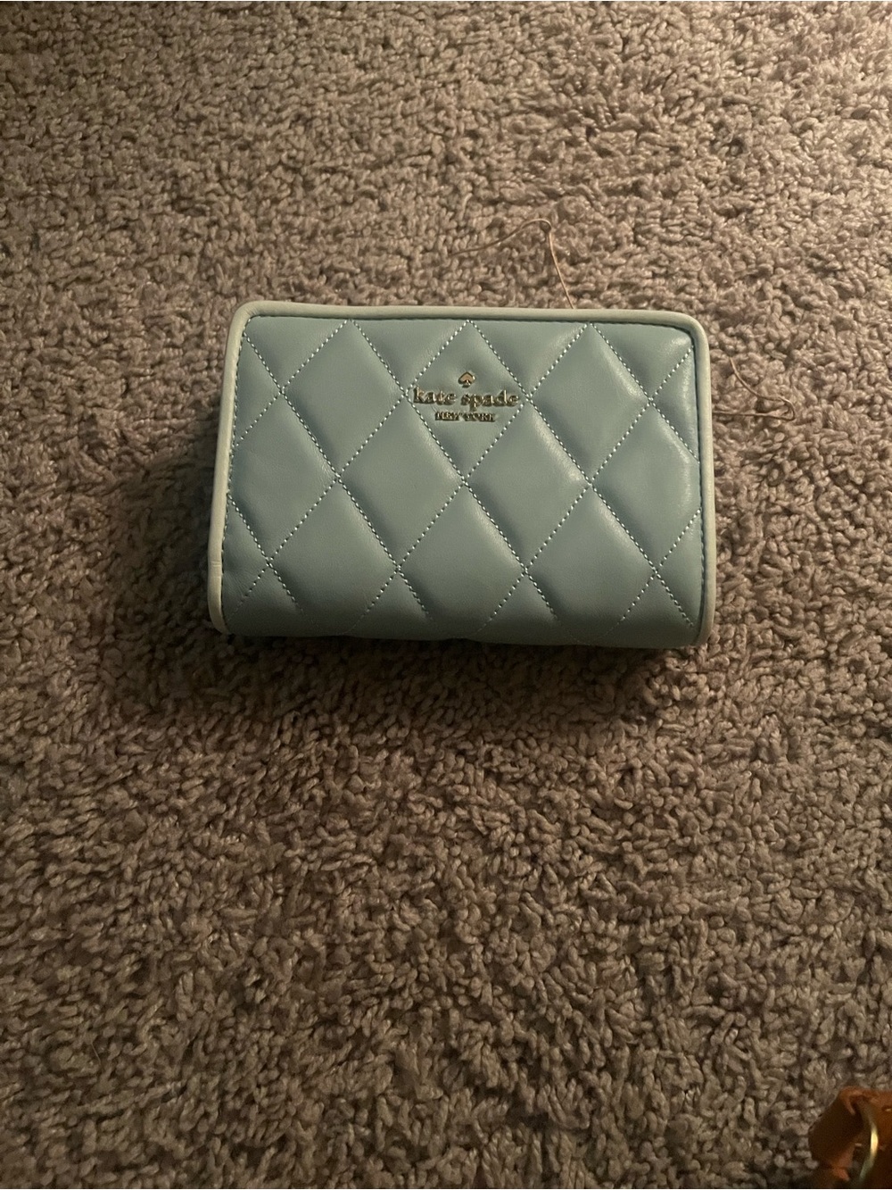 kate spade quilted small zip wallet in pale blue with gold logo